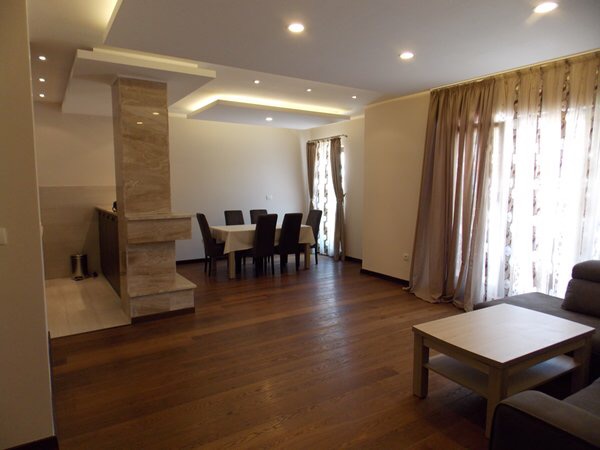 Spacious living room with dining area and marble finishes in an apartment in Budva, Montenegro. Modern interior.