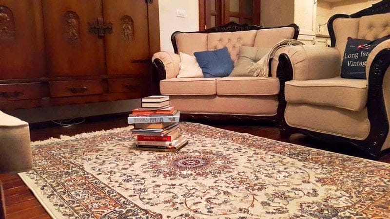 Villa living room in Krimovica, Montenegro: classic furniture, an antique cabinet, and a rug with an oriental pattern.