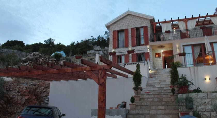 Two-story stone villa in Krimovica, Montenegro: terrace with pergola, stone staircase, and parking by the house.