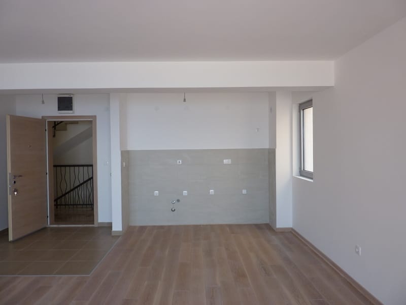 Bright kitchen-living room with finishes ready for furniture installation in a new apartment in Pržno, Montenegro.