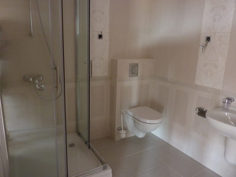 Bathroom with shower cabin and wall-hung toilet in an apartment, Pržno, Montenegro: modern light finish.