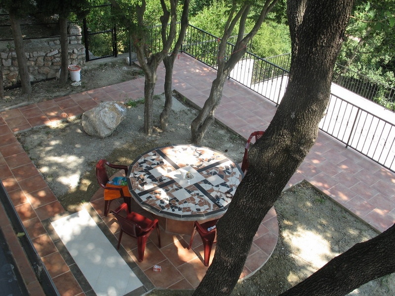 Cozy terrace with a mosaic table and garden furniture in a private house, Sutomore, Montenegro.