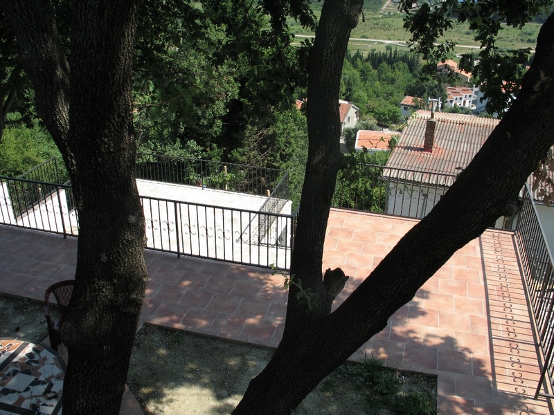 Spacious terrace with wrought-iron railing and a view of greenery in a house, Sutomore, Montenegro.
