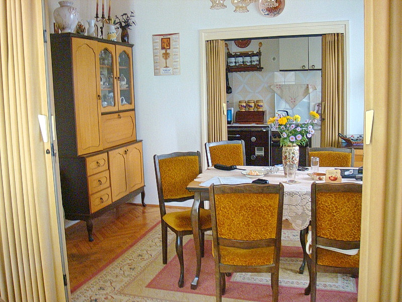 Living room interior with a dining area and vintage furniture in a house, Baošići, Montenegro.