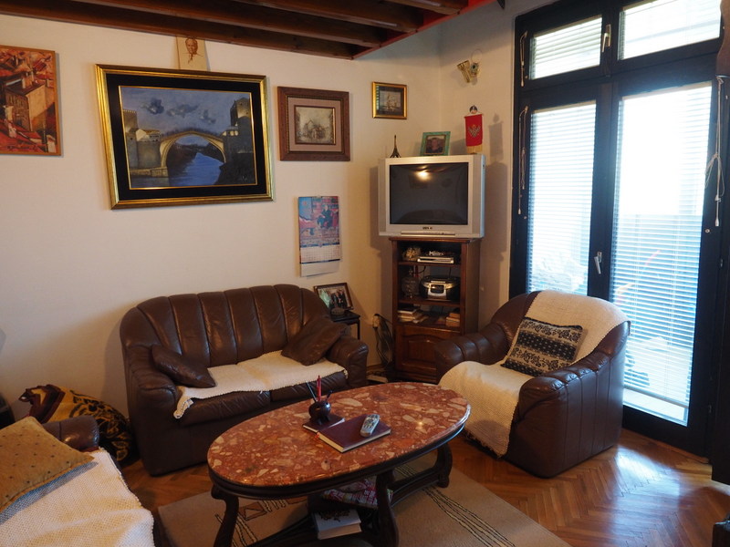 Living room in an apartment in Bar, Montenegro: leather furniture, a marble coffee table, and access to the balcony.