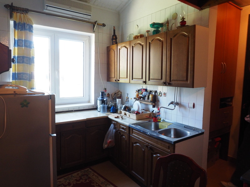 Kitchen with wooden cabinets and sink in an apartment for sale in Bar, Montenegro.