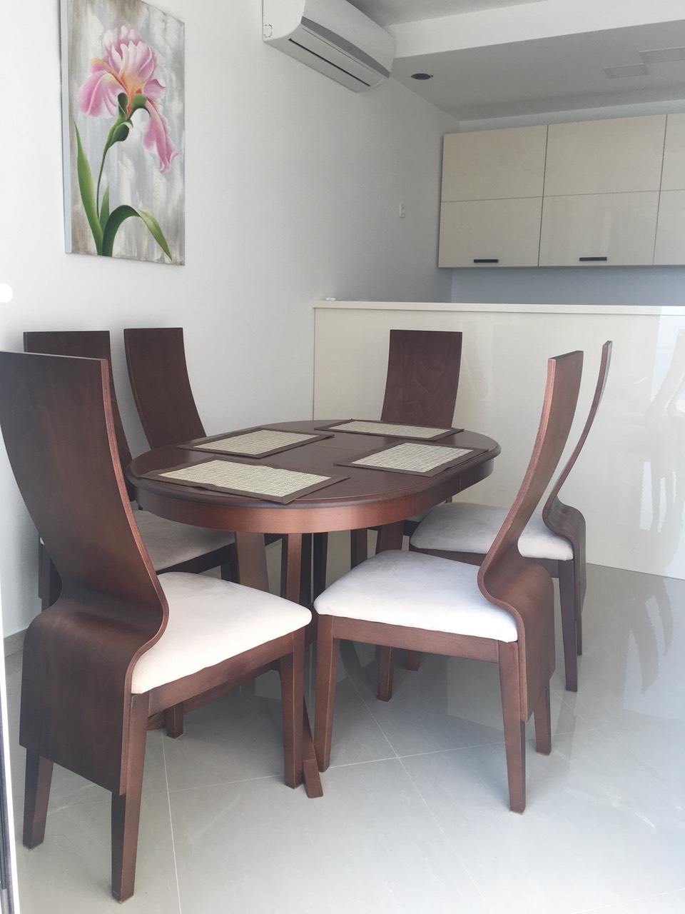 Dining area in the living room of a house in Shushan, Bar Riviera, Montenegro: wooden table, chairs, and a bright kitchen.