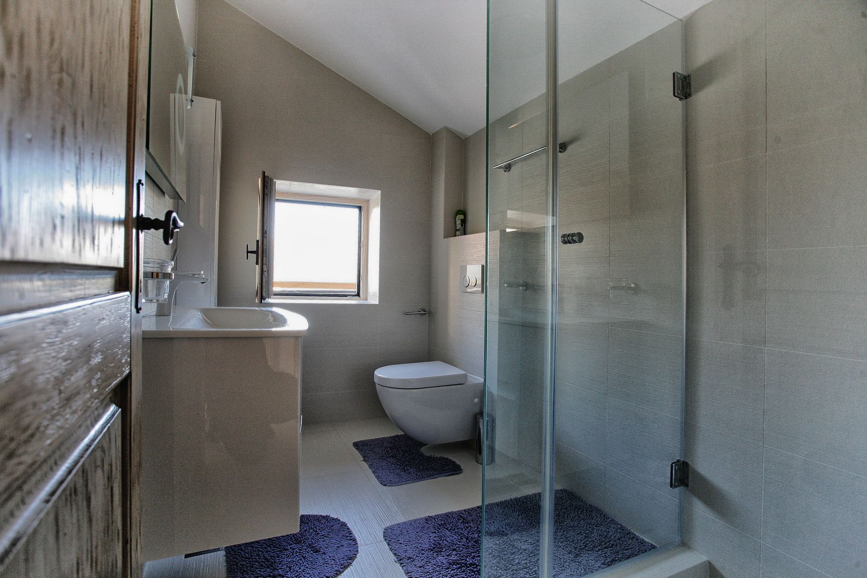 Modern bathroom with a shower cabin and light finishes in a villa in Reževići, Montenegro.