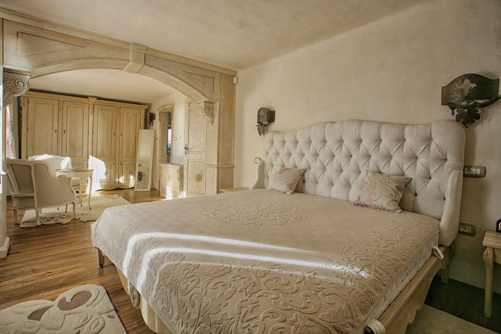 Bedroom in a classic style in a villa in Reževići, Montenegro: a double bed with a soft headboard and wooden decor.