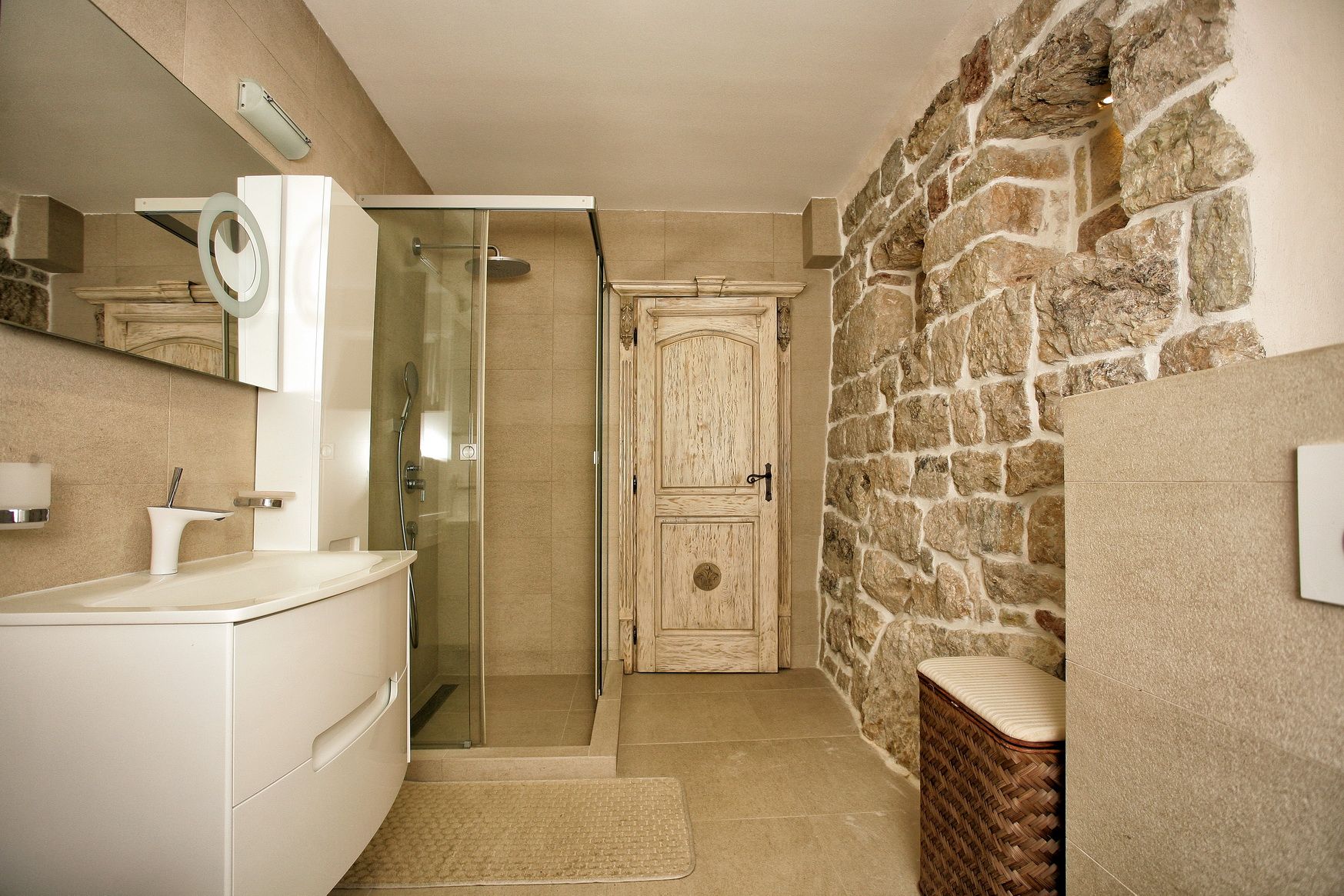 Modern bathroom with a shower cabin and natural stone finishes in a villa in Reževići, Montenegro.
