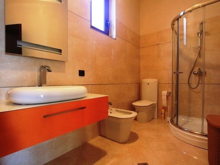 Modern bathroom with a shower cabin and a bright vanity in a villa in Petrovac, Montenegro.