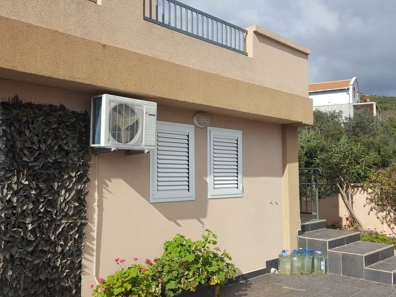 House facade in Krimovica, Montenegro: tiled terrace, air conditioner, windows with shutters, and stairs, exterior view of property 1119