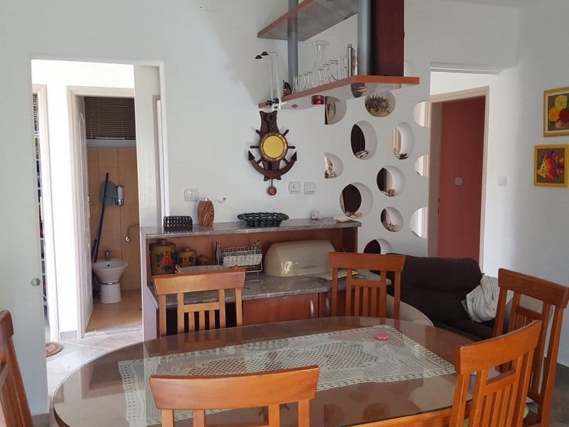 Living room with dining area and decorative partition in a house, Krimovica, Montenegro: wooden furniture and interior.