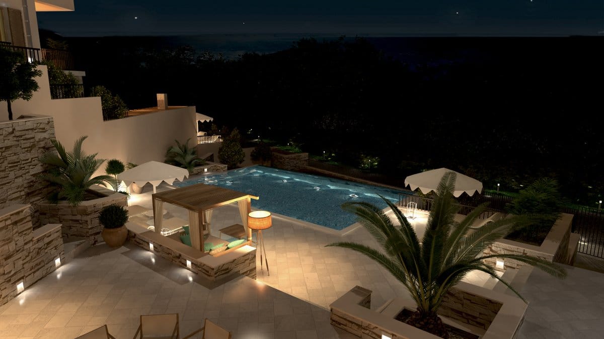 Pool with lighting and a lounge area at a villa in Reževići, Montenegro: terrace with palm trees and a night sea view.