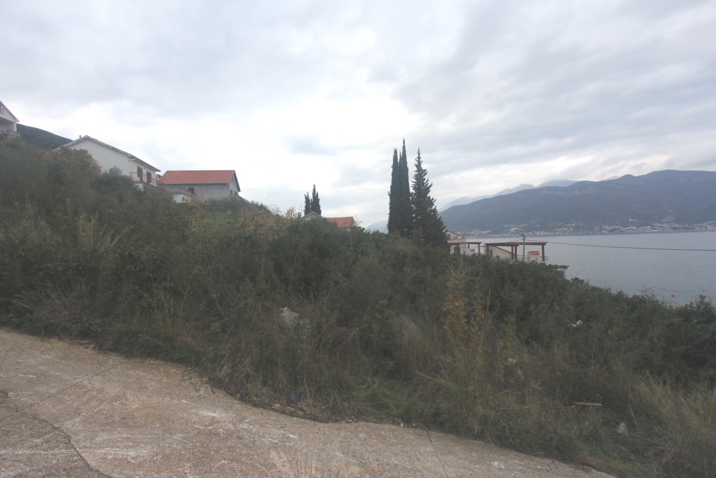 Building plot in Krašići, Montenegro with panoramic sea and mountain views, access road.
