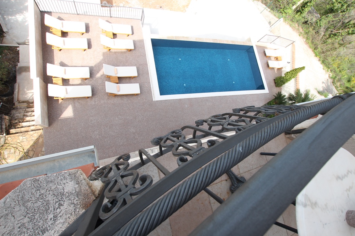 View from the balcony of a private pool with sun loungers by the house in Sutomore, Montenegro.