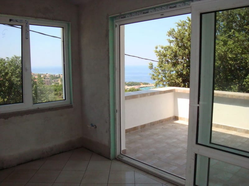 Living room with access to the terrace and sea view in a house, Uteha, Montenegro. Space ready for finishing.