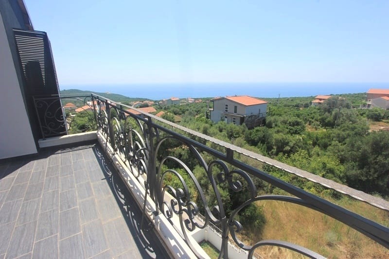 Balcony with wrought-iron railing and panoramic sea view in a house, Krymovitsa village, Montenegro.
