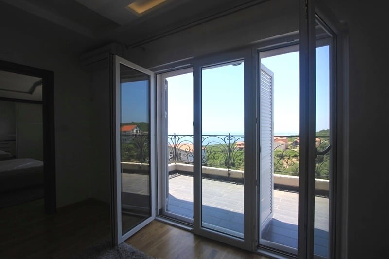 Living room with access to the terrace and panoramic sea view in the house, Krimovica, Montenegro.