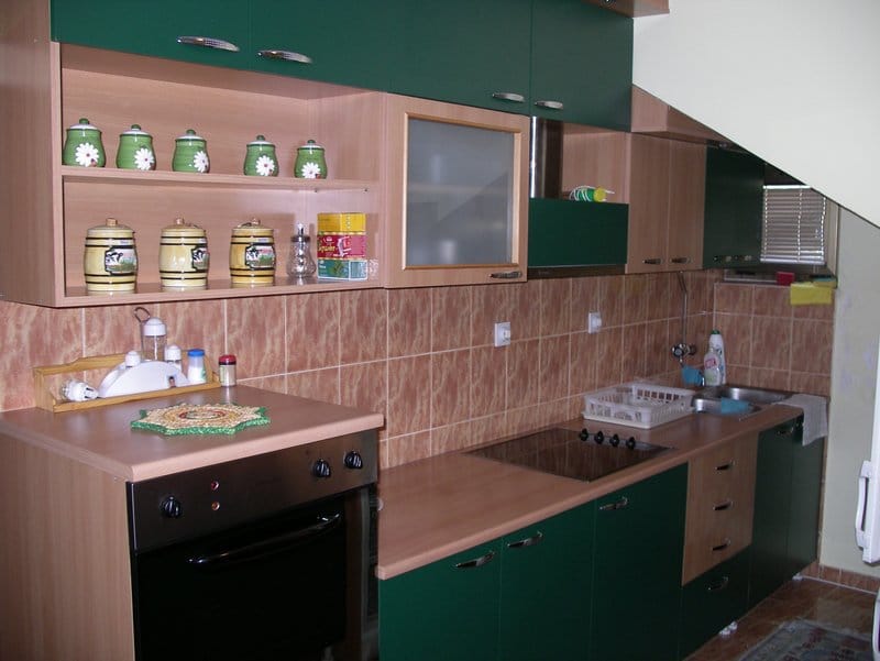 Kitchen with green fronts and built-in appliances in an apartment for sale in Baošići, Montenegro.