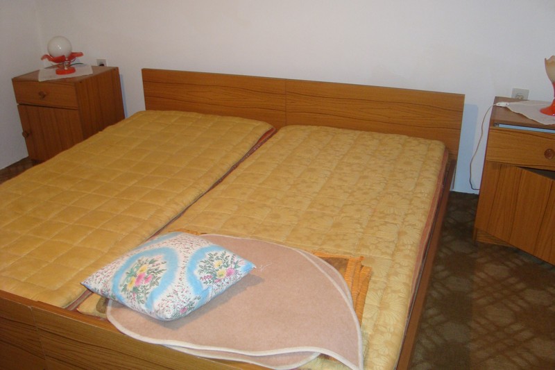 Bedroom with a double bed and bedside tables in a house for sale, Dobrota, Montenegro.