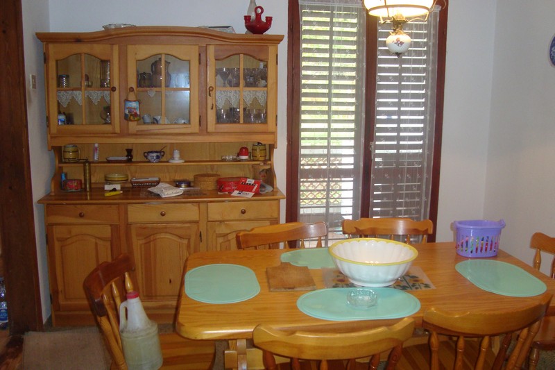 Kitchen with a wooden sideboard and dining table in a house for sale in Dobrota, Montenegro.