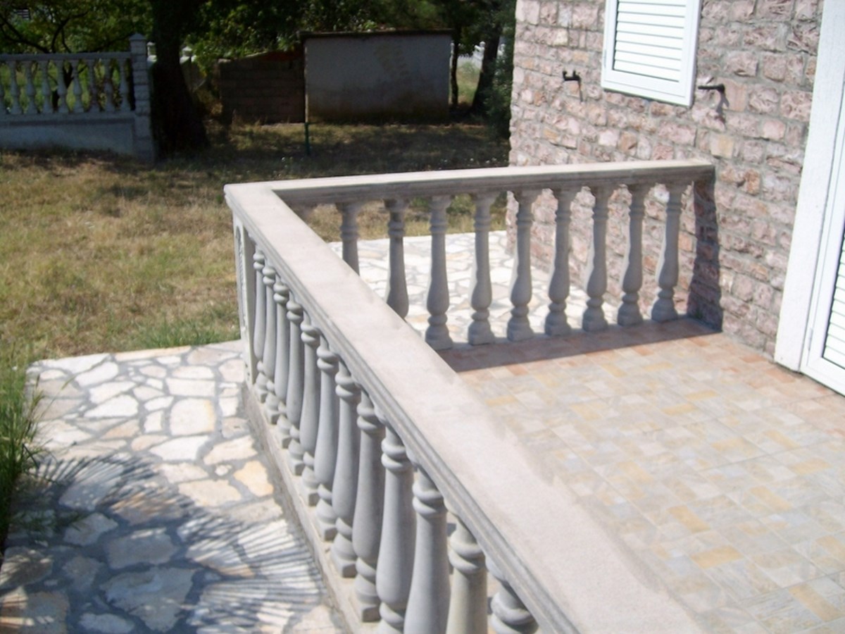 Open terrace with stone balusters and tiled flooring on a villa in Bar, Montenegro.