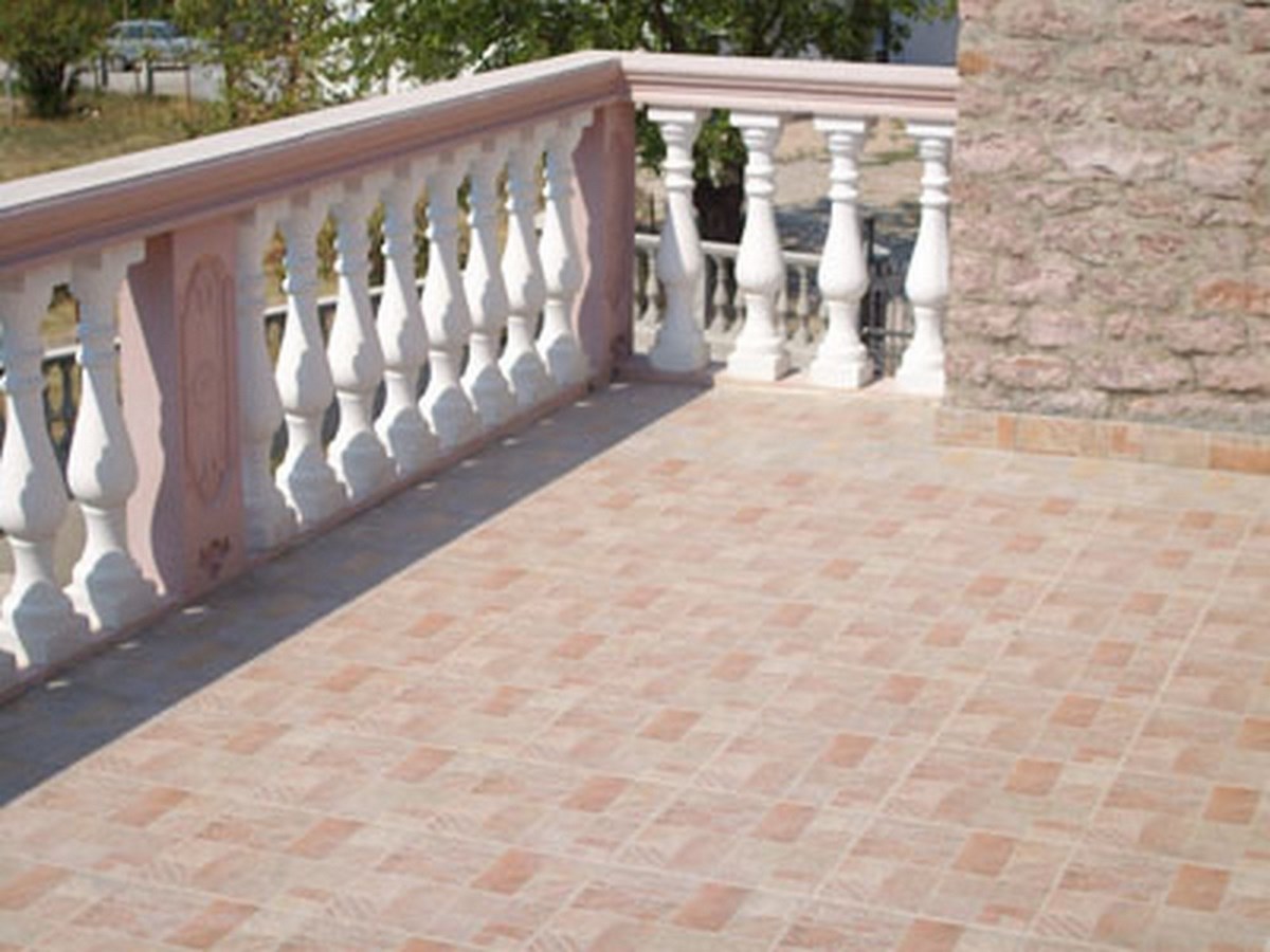 Spacious terrace with balustrade and stone finishes on a villa in Bar, Montenegro.
