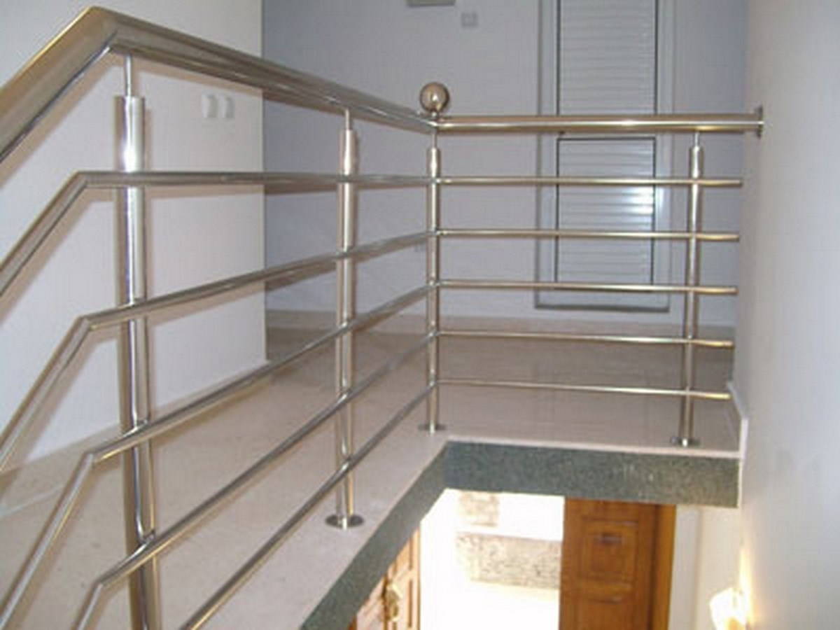Modern stainless steel railings on the staircase of a villa in Bar, Montenegro, with light stone finishes.