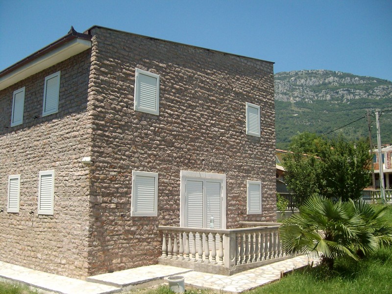 Two-story natural stone villa with a terrace and mountain views in Bar, Montenegro.