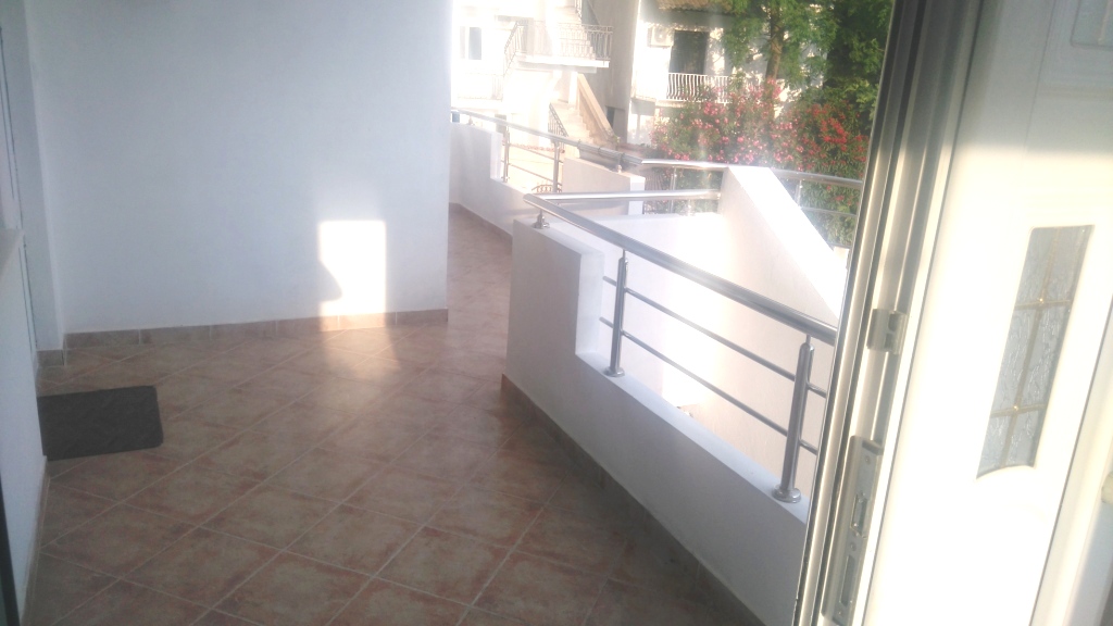 Spacious open terrace with tiled floor and metal railing in a house, Shushan, Montenegro.