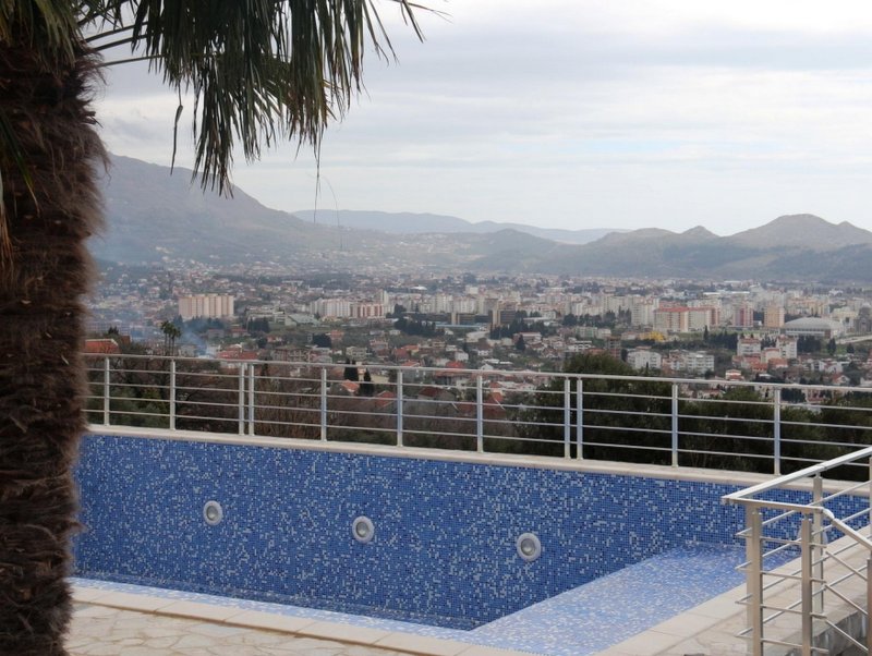 Pool with blue mosaic and panoramic views of the city of Shushan and the mountains, Montenegro.