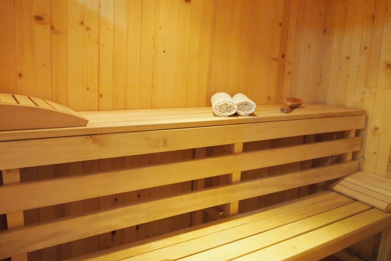 Wooden sauna with shelves and bath accessories in a hotel in Bečići, Montenegro.