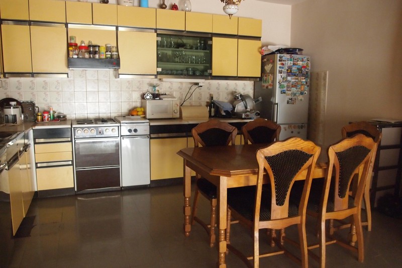 Kitchen with yellow furniture and a dining area in a hotel, Bečići, Montenegro. Cozy interior for relaxation.