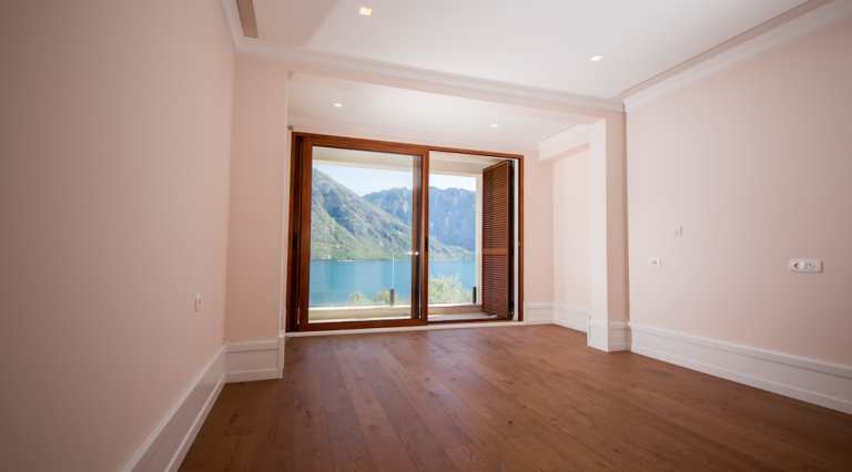 Bright living room in a house in Stoliv, Montenegro, with panoramic views of the sea and the mountains of Boka Bay.