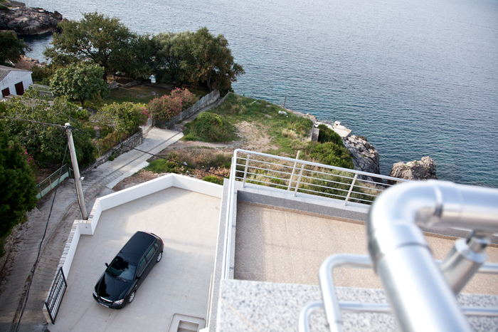 View from the terrace of the sea and parking by the house in Dobra Voda, Montenegro. Modern finishes, stainless steel railings.