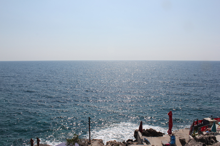 Panoramic view of the Adriatic Sea from the apartment terrace in Dobra Voda, Montenegro, with access to a rocky beach.