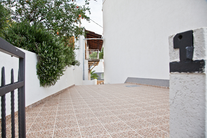 Open terrace with tiled flooring and greenery by the house in Dobri Vody, Montenegro.