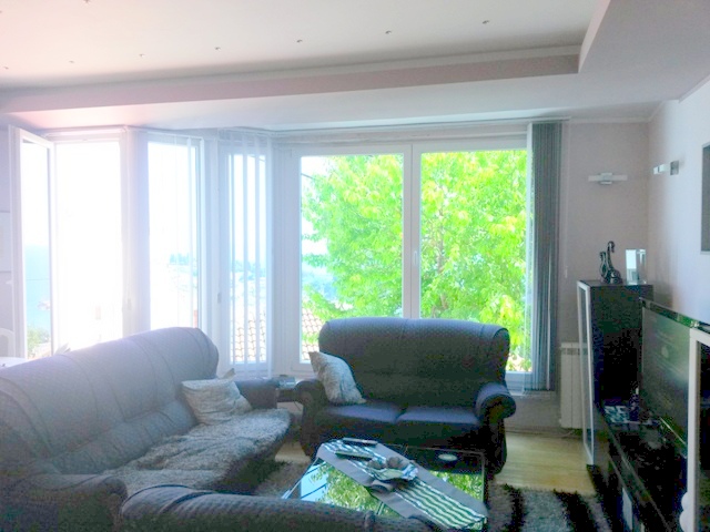 Bright living room with soft furniture and panoramic windows in a house, Ulcinj, Montenegro.