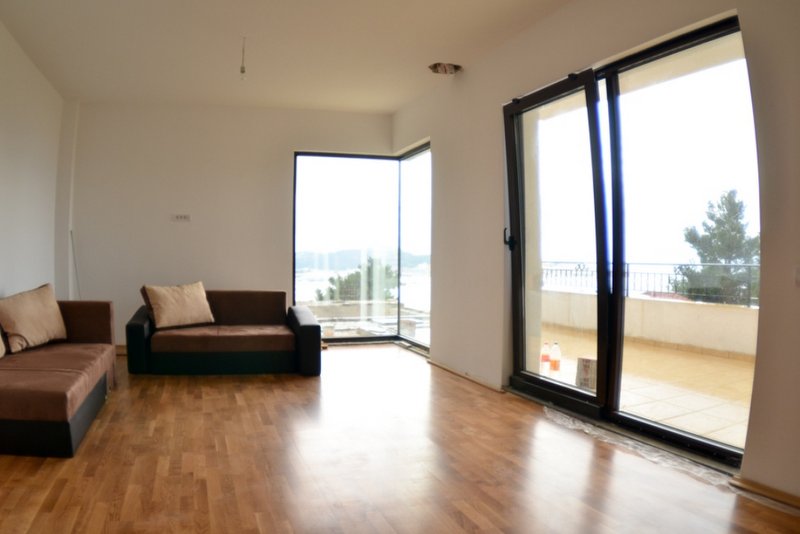 Living room with panoramic windows, access to the terrace, and sea view in a house, Shushan, Montenegro.