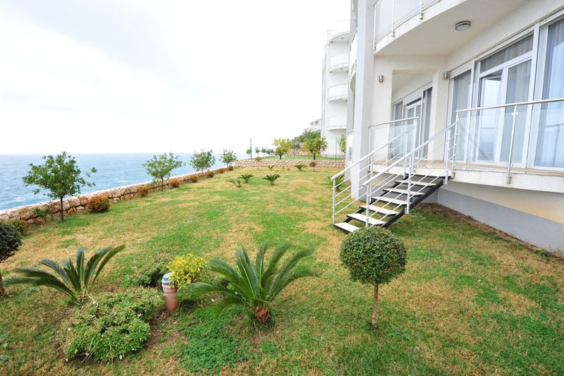 Apartment terrace in Dobri Vody, Montenegro: sea view, private green plot, and direct access from the apartment to the lawn.