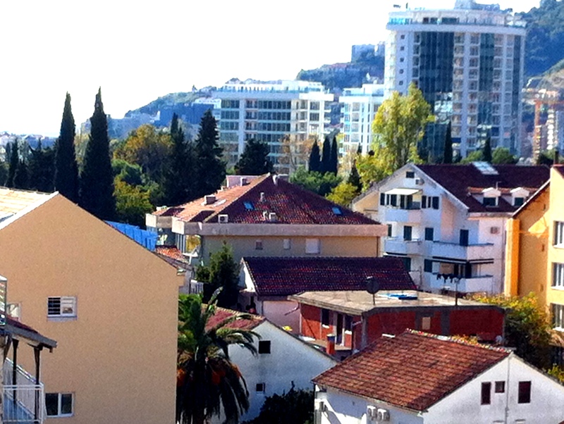 Panoramic view of the cityscape and modern residential complexes in Budva, Montenegro, from the apartment terrace.