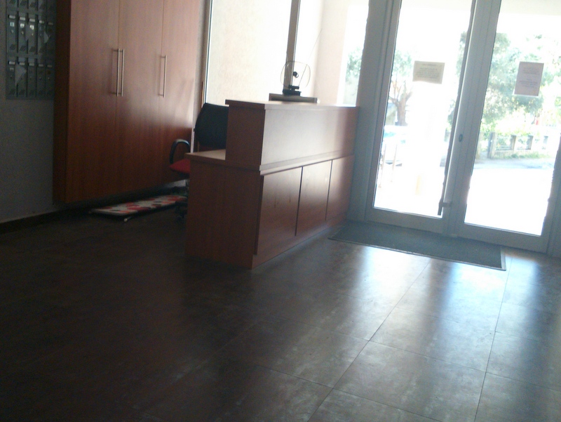 Reception desk and mailboxes in the lobby of a residential complex in Budva, Montenegro. Modern interior with panoramic windows.