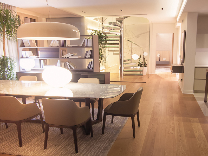 Modern living room in Dukley Gardens, Bečići, Montenegro: dining area, designer spiral staircase, and decor.