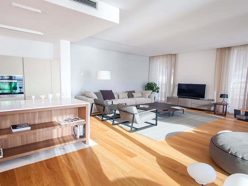 Modern living room in Dukley apartments, Becici, Montenegro: bright interior, kitchen island, and soft seating.