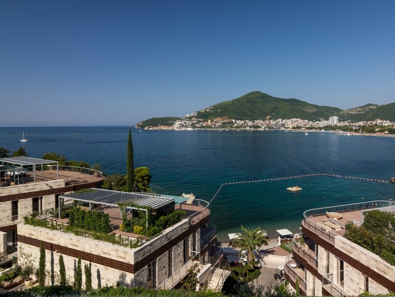 Sea view and the Dukley Gardens complex in Bečići, Montenegro: modern villas with terraces and a private beach.