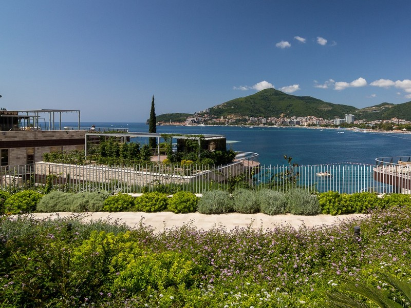 Sea and Bečići Beach view from Dukley Gardens complex, Montenegro: landscaped design, terraces, and panoramic scenery.