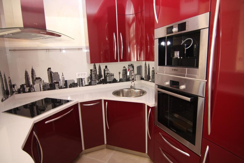 Modern red kitchen with Bosch appliances and a city-print backsplash in a villa in Lastva, Montenegro.