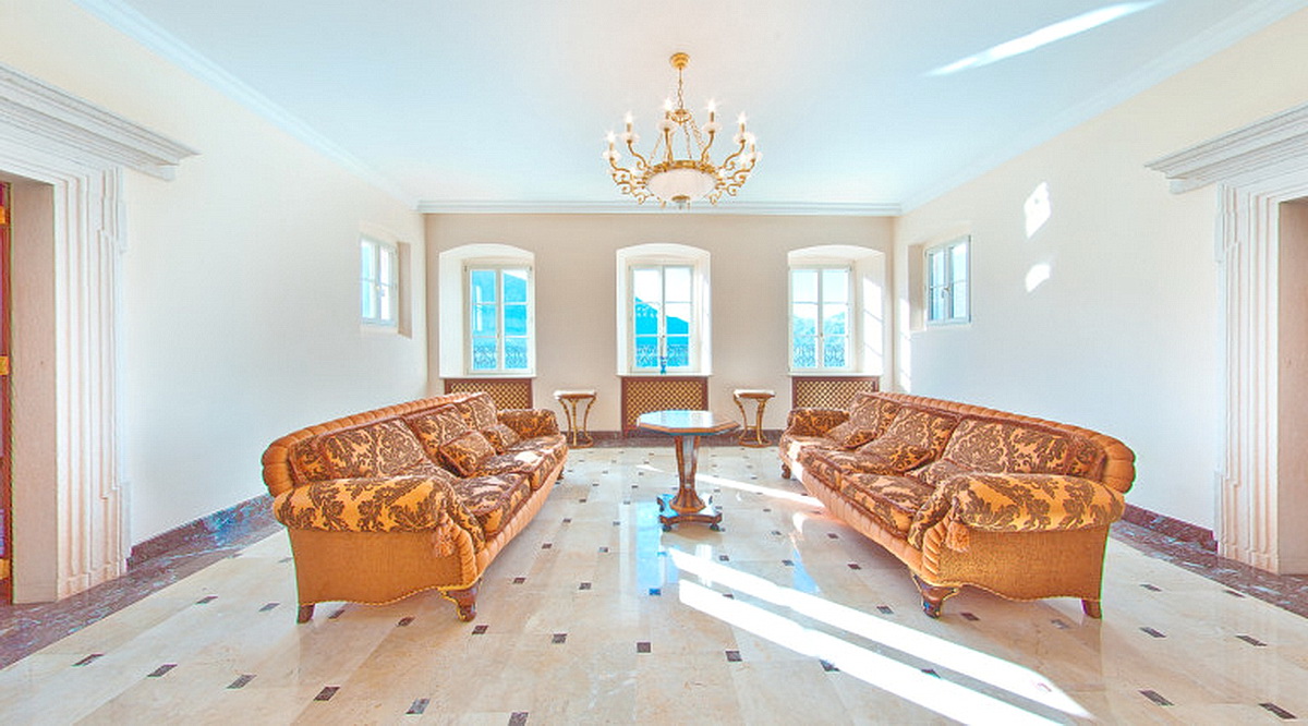 Luxurious living room with classic furniture and marble flooring in a villa in Dobrota, Montenegro. Mountain view from the windows.