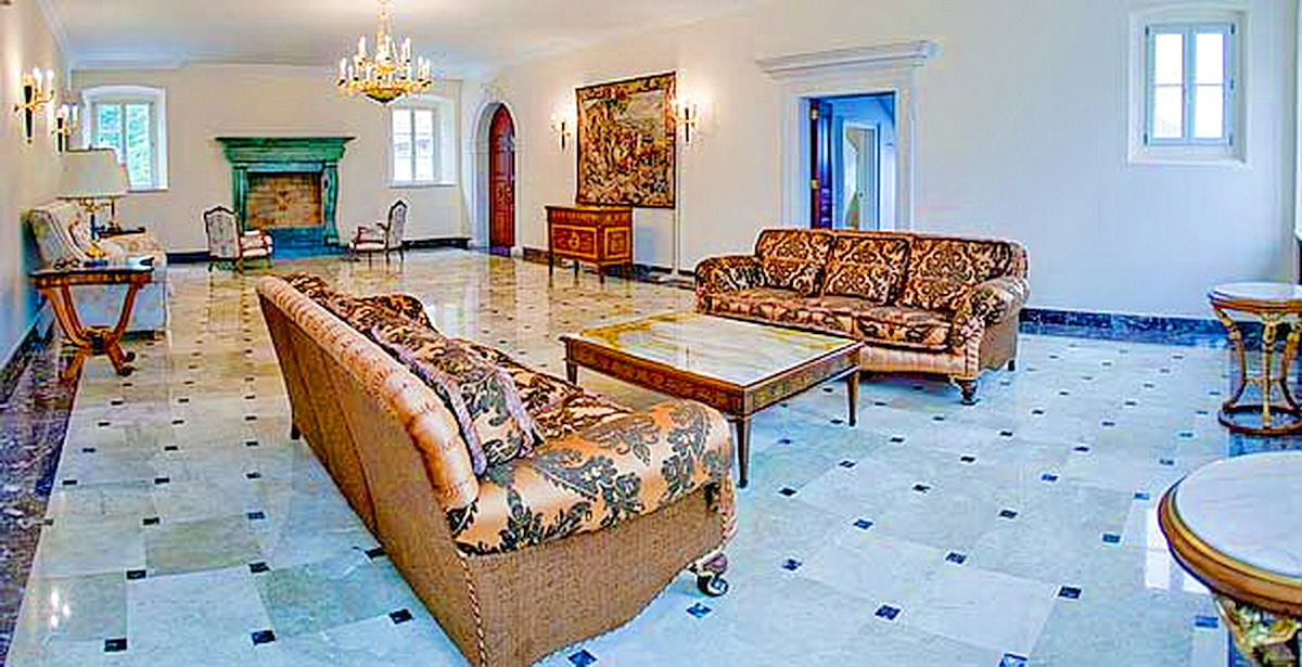 Luxurious living room with marble floor and fireplace in a villa in Dobrota, Montenegro: classic furniture and decor.
